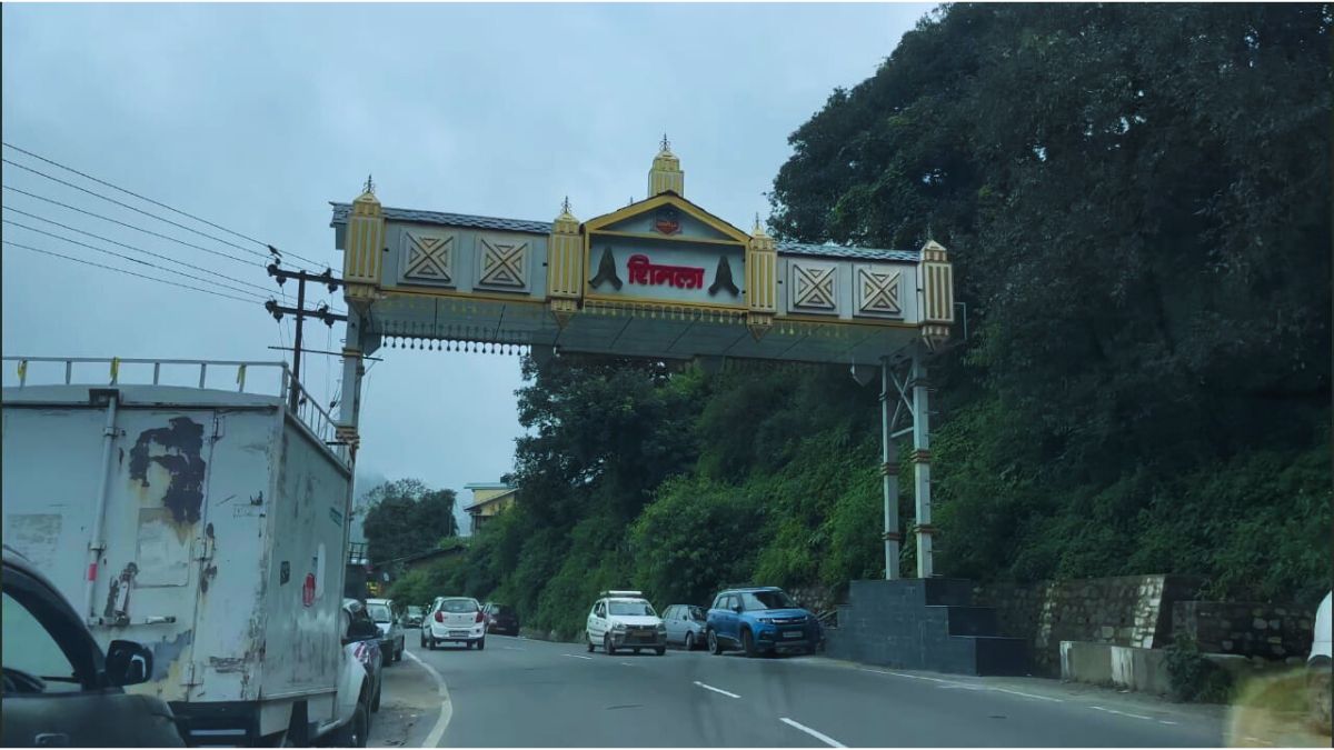 Scenic highway view on Delhi to Shimla route with hills and pine trees in the background