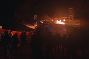 "Lively crowd enjoying Magica Festival in Kasol during June with music and colorful lights" 