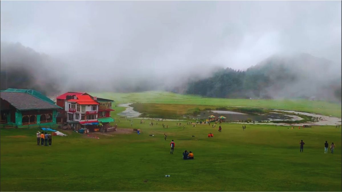 “Khajjiar meadow covered in monsoon mist and pine trees”