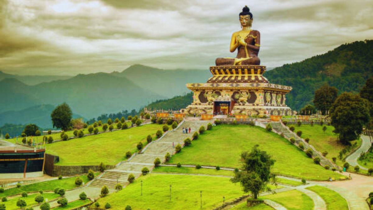 Golden Buddha statue overlooking Langza village and Chau Chau Kang Nilda peak