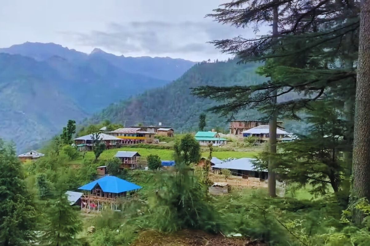 Sacred meadow of Shangarh in Sainj Valley, Himachal Pradesh with traditional temple and green pastures 