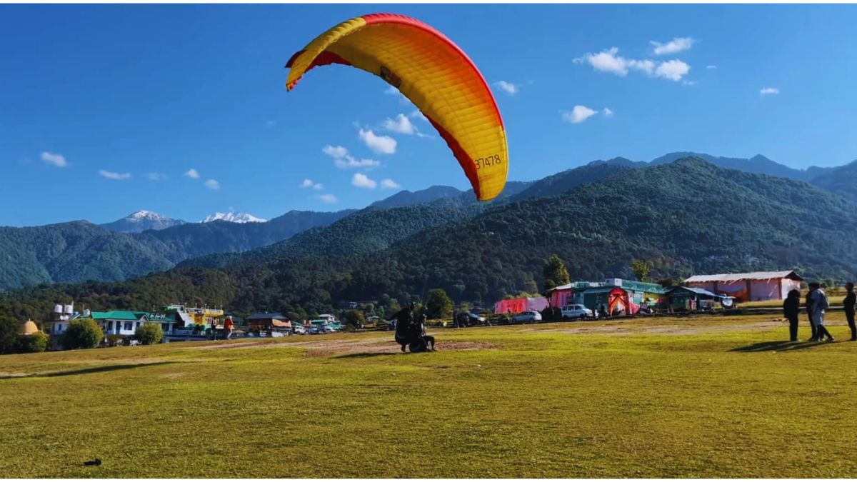  Couple paragliding over Bir Billing valley during honeymoon