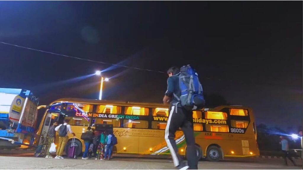 Volvo bus on a scenic mountain road from Delhi to Kasol along the Parvati Valley in 2025