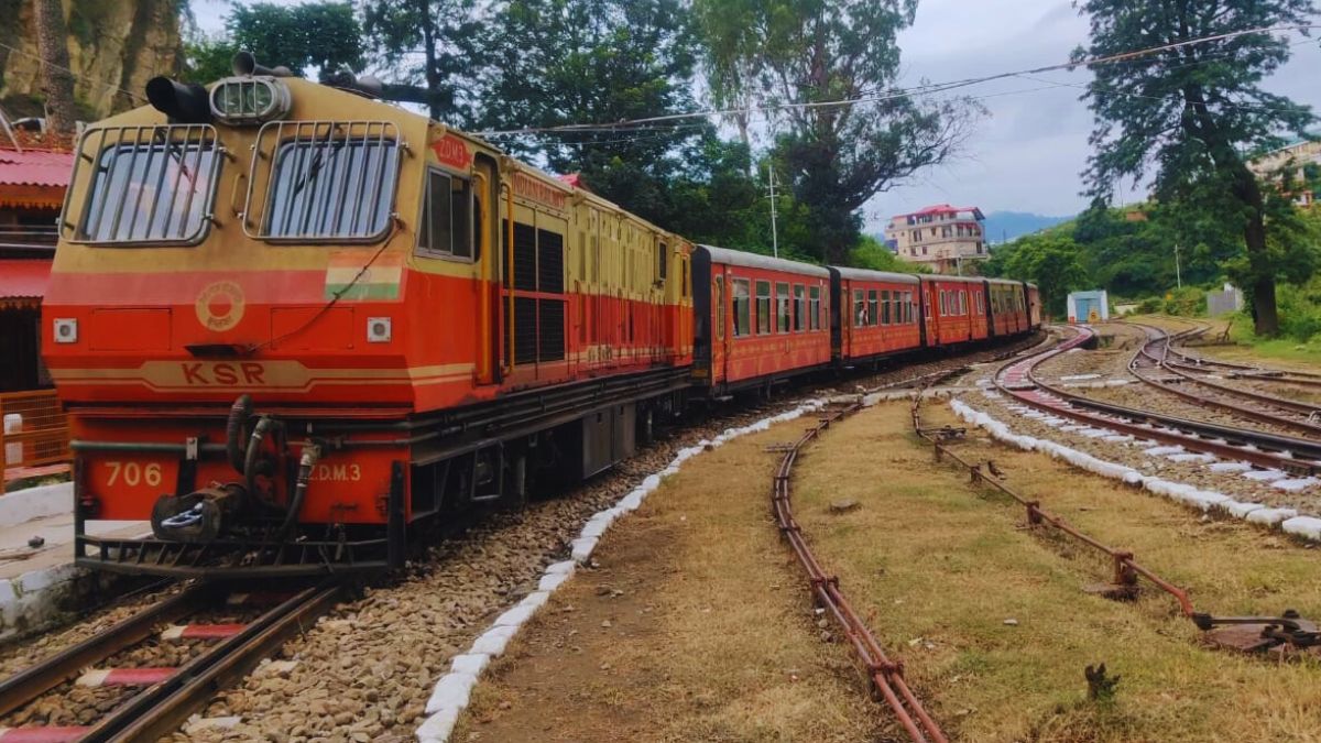 Kalka to Shimla toy train traveling through pine-covered Himalayan hills on UNESCO heritage railway