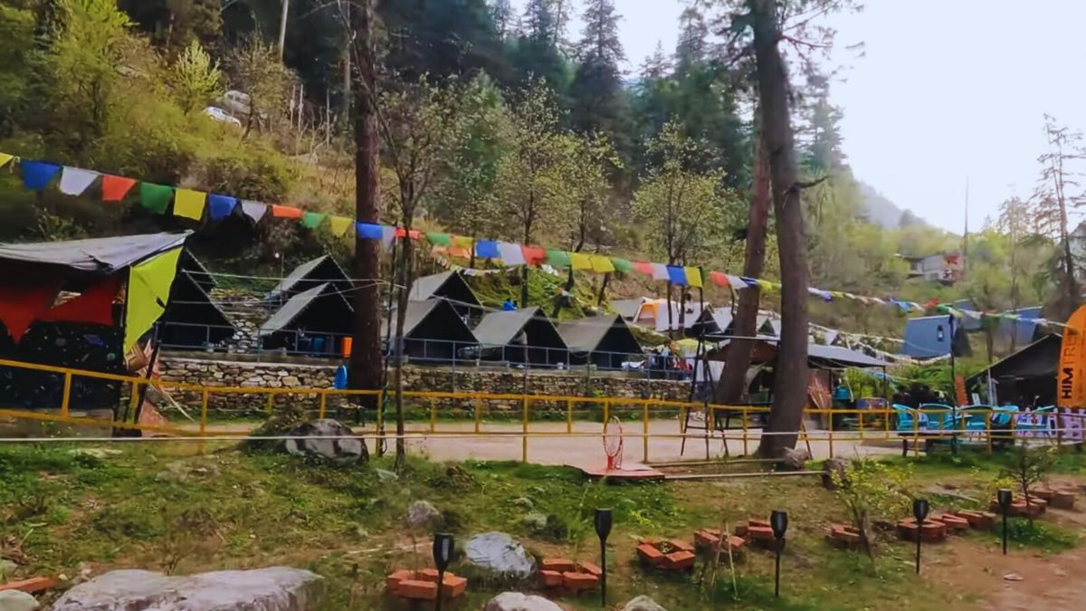Backpacker relaxing at a riverside café in Kasol in 2025