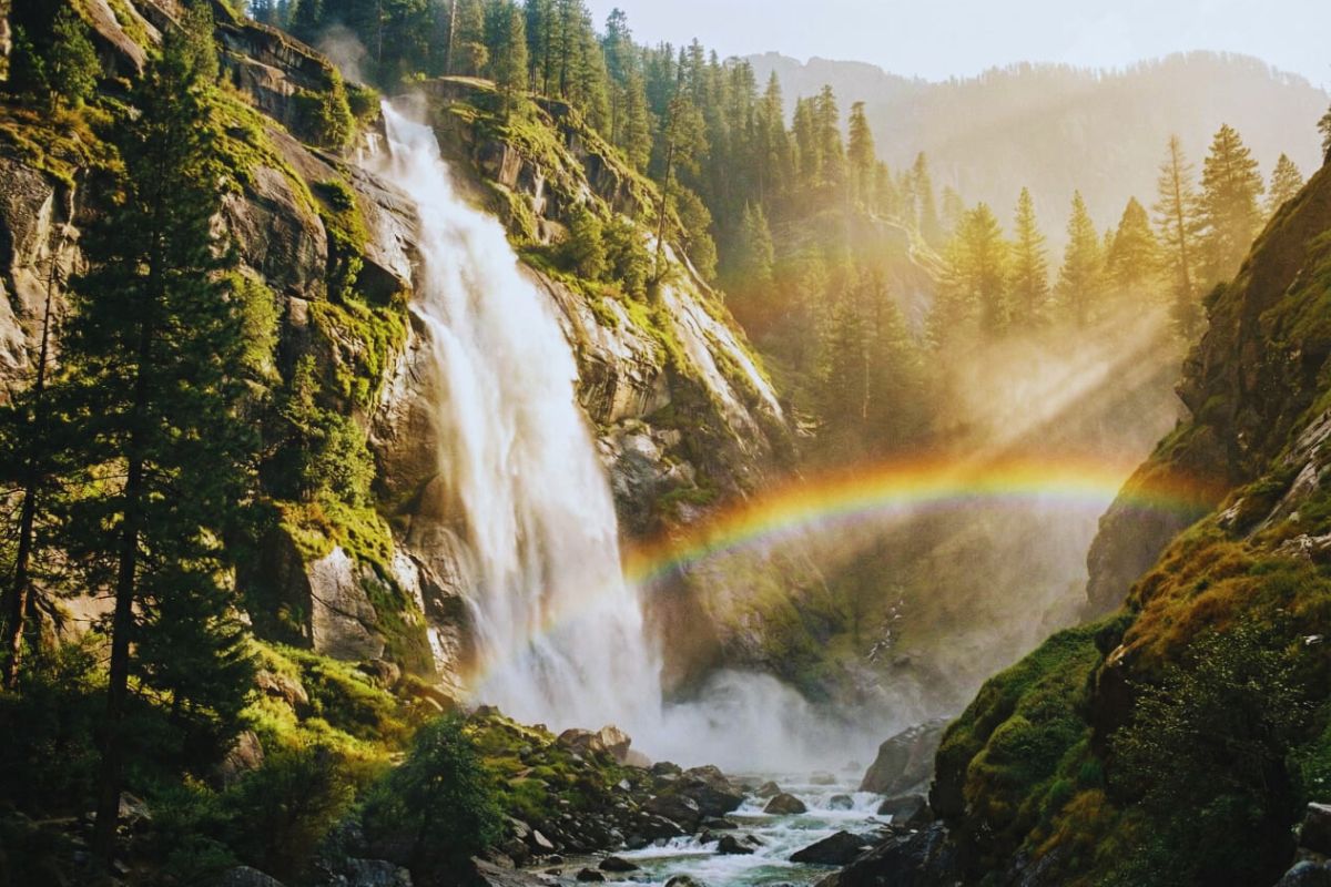 Tall waterfall at Sissu surrounded by cliffs in Lahaul Valley.